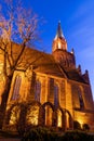 Trzebiatow, zachodniopomorskie / Poland Ã¢â¬â November, 30, 2019: Church illuminated by spotlights at night. Christian temple in